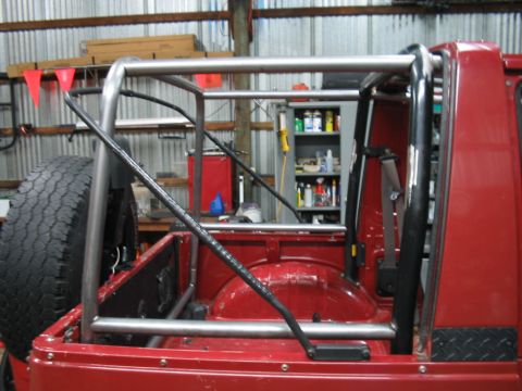 1987 Suzuki Samurai - This vehicle has a custom roll cage installed. The spare tire is mounted externally on the rear.