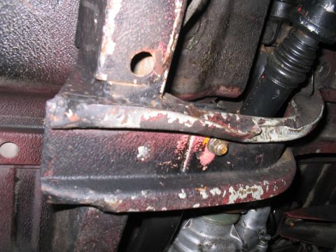 1987 Suzuki Samurai - Detail of a corroded chassis bracket, likely from the undercarriage of a vehicle.