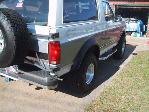 1994 Ford Bronco - This Ford Bronco features a two-tone paint scheme and a rear-mounted spare tire.