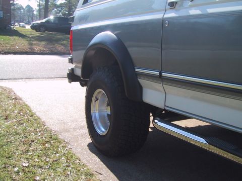 1994 Ford Bronco - This Ford Bronco features aftermarket fender flares and large tires, with a two-tone paint scheme.
