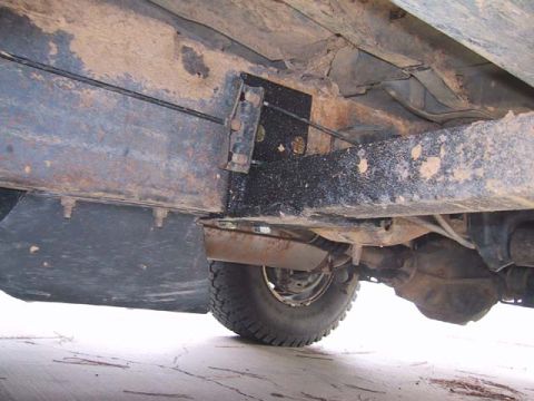 1995 Ford Bronco - Close-up view of the undercarriage, revealing the vehicle's frame and suspension components.