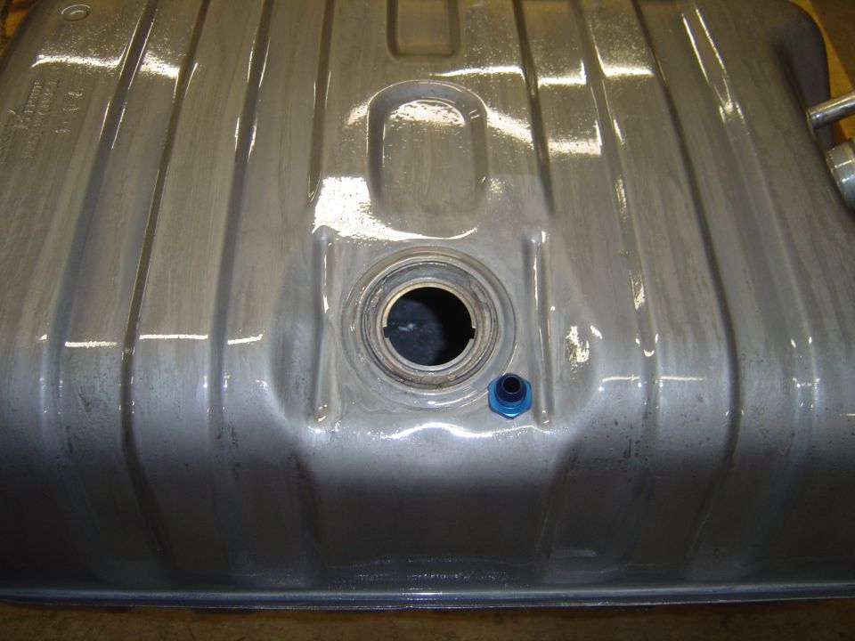 Metal fuel tank with ribbed exterior and central filler neck opening