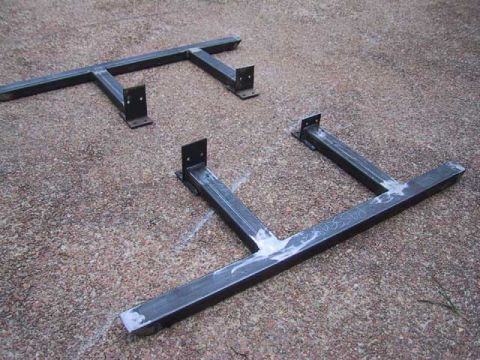 1995 Ford Bronco - Two custom metal sliders with mounting brackets are shown on a gravel surface.
