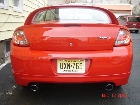2005 Dodge SRT-4 - Rear view of a red 2005 Dodge SRT-4, showing its distinctive taillights and dual exhaust pipes.