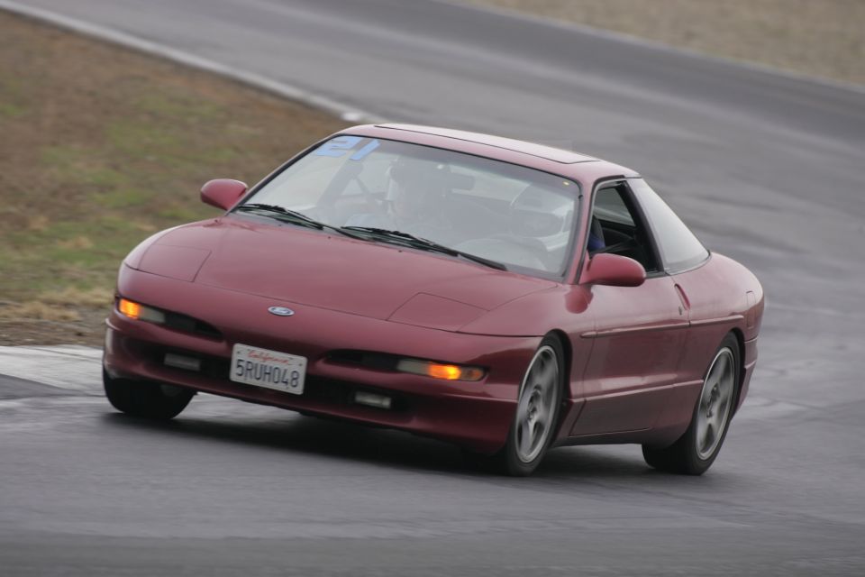 Red 1993 Ford Probe on track, front 3/4 view. California plate 5RUH048