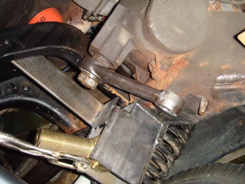 1996 Ford Bronco - Steering linkage component with custom bracket and spring visible.
