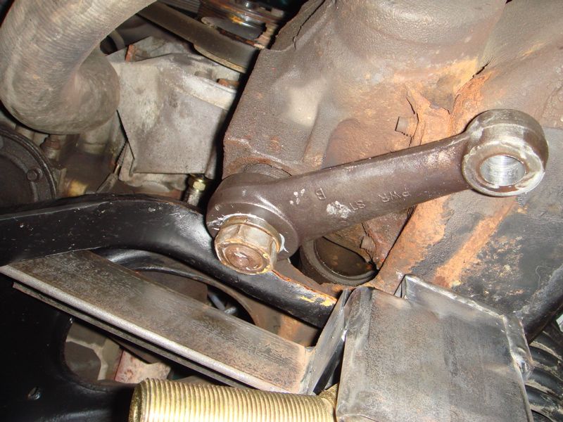 close-up of a rusty steering linkage part with "PWR STR" visible
