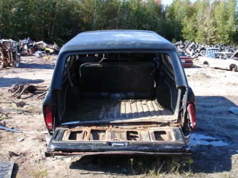 1996 Ford Bronco - This vehicle appears to be in a junkyard, with its rear cargo area exposed and showing signs of wear.