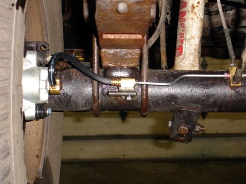 1996 Ford Bronco - Rear axle brake caliper and brake line detail.
