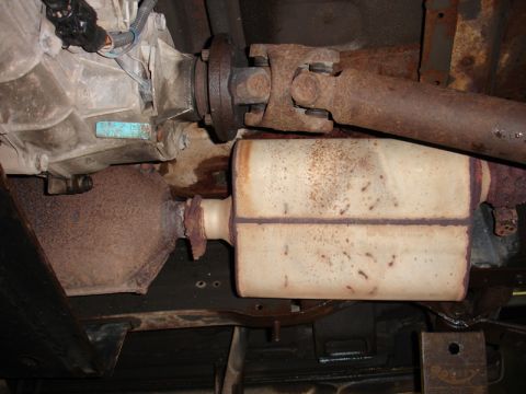 1996 Ford Bronco - Underside view of a vehicle's exhaust system, including the catalytic converter and muffler.
