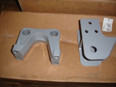 1996 Ford Bronco - Two gray metal suspension parts are shown on a cardboard box, with a label visible on the right part.