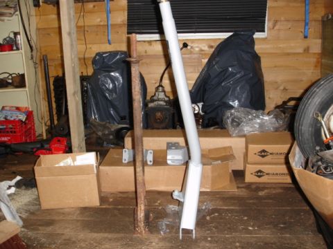1996 Ford Bronco - Various automotive parts and equipment are stored in a workshop setting.