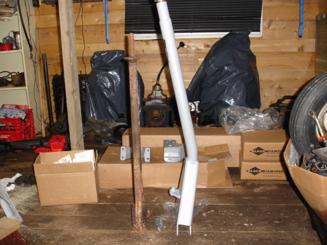 Workshop scene with engine parts, boxes, and a white metal component