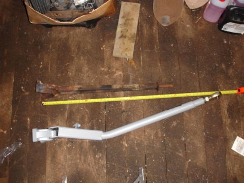 1996 Ford Bronco - A close-up view of automotive parts laid out on a wooden floor with a measuring tape.