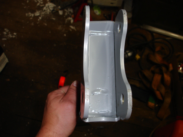 Gray metal bracket held by a hand