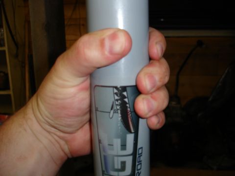 1996 Ford Bronco - Cylindrical part with 'GF OFFROAD' branding and shark graphics held in hand.