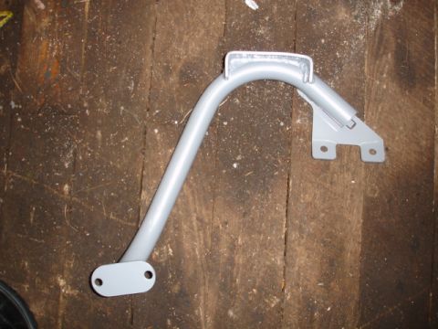 1996 Ford Bronco - A single metal bracket is shown against a wooden background.