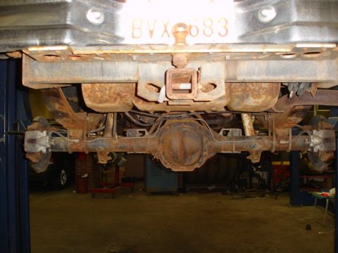1996 Ford Bronco - The rear suspension and axle of a 1996 Ford Bronco show extensive rust and wear.