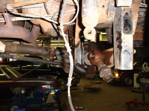 1996 Ford Bronco - Close-up view of the undercarriage of a vehicle, showing suspension and drivetrain parts.