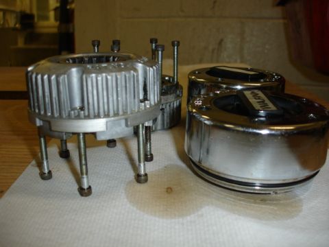1996 Ford Bronco - Two chrome Warn locking hubs are shown, one with visible text, alongside a silver hub with bolts.
