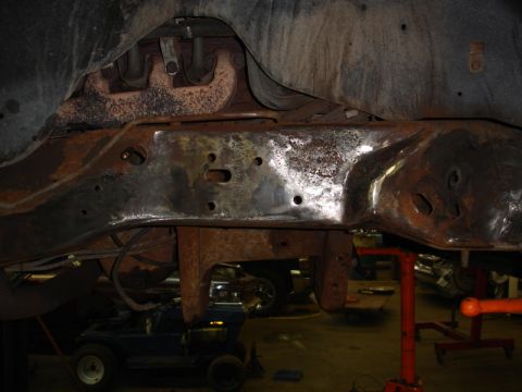 1996 Ford Bronco - Close-up view of a heavily rusted vehicle frame and exhaust system, suggesting significant wear and tear.