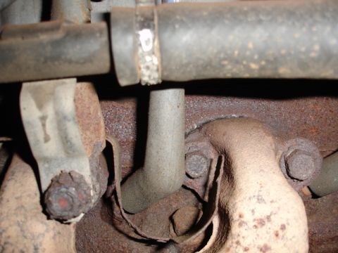 1996 Ford Bronco - Detail of a corroded exhaust system component, likely from an older vehicle.