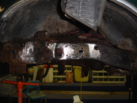 1996 Ford Bronco - The underside of a vehicle is shown with frame damage and repair work in progress.