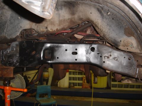 1996 Ford Bronco - Underside view of a vehicle's frame and suspension components, likely undergoing maintenance or restoration.