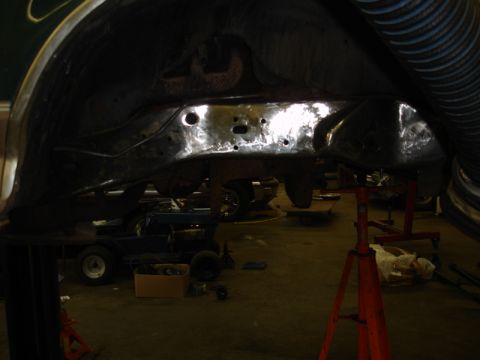 1996 Ford Bronco - The vehicle's frame and suspension are visible as it's elevated for maintenance in a workshop setting.
