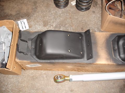 1996 Ford Bronco - Various automotive suspension components laid out on a concrete surface.