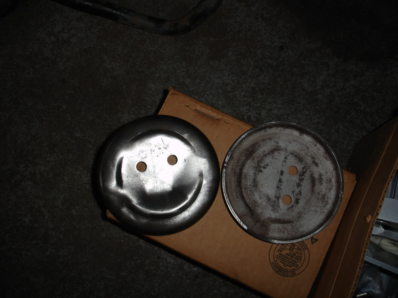 Two metal discs, one with a smiley face, sit on a cardboard box