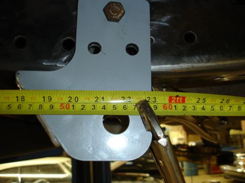 1996 Ford Bronco - Measuring a suspension component with a tape measure and vise grips.