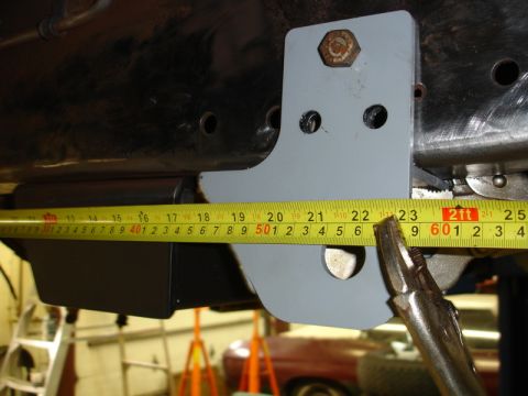 1996 Ford Bronco - A bracket is being measured on a vehicle's frame, indicating a modification or repair process.