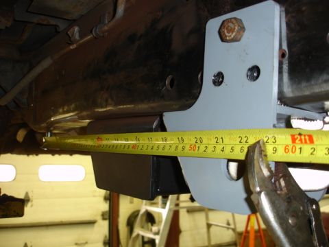 1996 Ford Bronco - Measuring bracket on vehicle frame with yellow tape measure and vise grips.