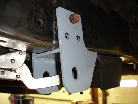 1996 Ford Bronco - A bracket is being attached to the vehicle's frame, possibly for modification or repair.