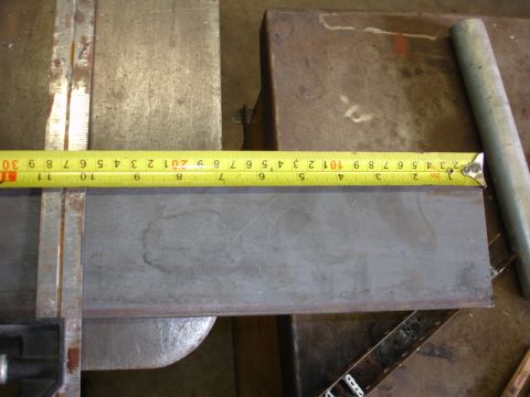 1996 Ford Bronco - A metal plate is measured with a tape measure, showing measurements in inches and centimeters.
