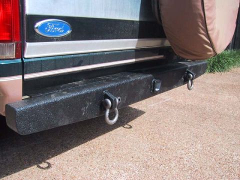 1995 Ford Bronco - Rear view of a dark green and tan Ford Bronco with a black aftermarket bumper and D-rings.