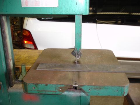 1996 Ford Bronco - A white SUV is partially visible behind a green band saw.
