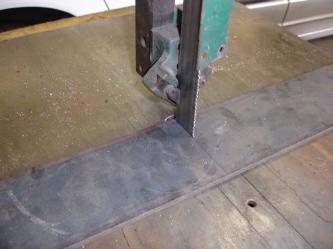 1996 Ford Bronco - Metal fabrication in progress with a bandsaw cutting a steel bar.