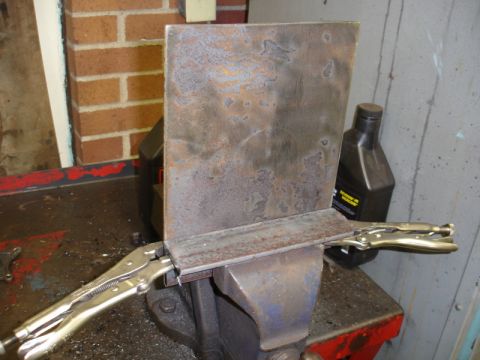 1996 Ford Bronco - Metal fabrication in progress, with two pieces of metal secured in a vise for welding.