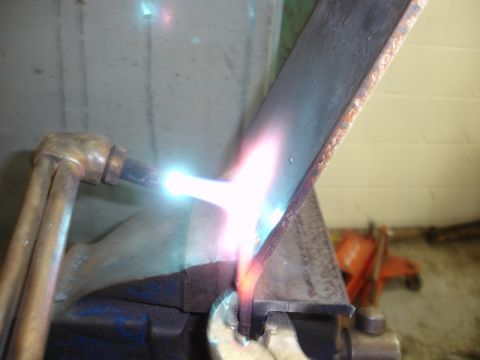 1996 Ford Bronco - Metal being cut with an oxy-acetylene torch in a workshop setting.