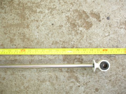 1996 Ford Bronco - A shock absorber is measured with a tape measure.