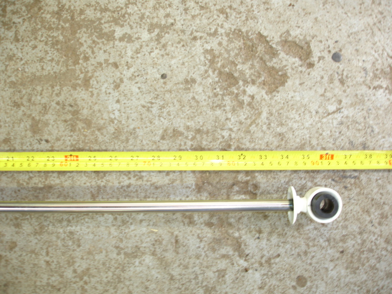 Shock absorber next to a yellow tape measure showing 30-39 inches