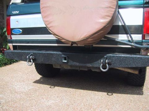 1995 Ford Bronco - Rear view of a 1995 Ford Bronco, showing the aftermarket bumper and spare tire cover.