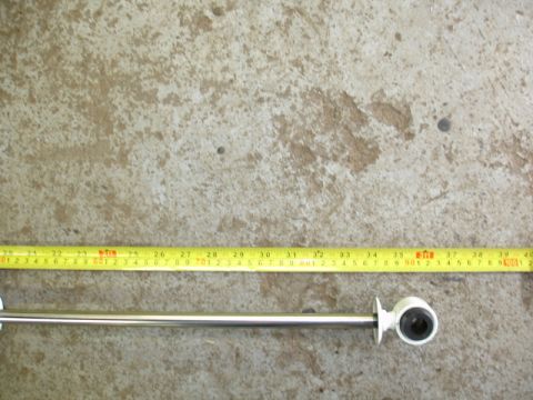1996 Ford Bronco - A metal rod with a rubber grommet is measured against a tape measure on a concrete surface.
