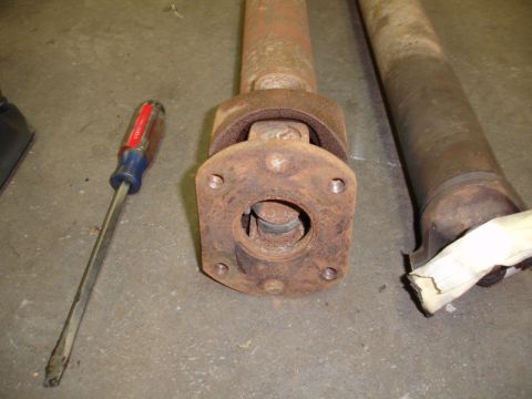 1996 Ford Bronco - Close-up of driveshafts and a screwdriver, likely automotive parts.