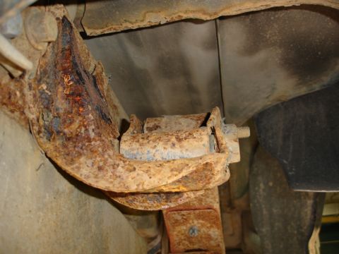 1996 Ford Bronco - Underside view of heavily corroded vehicle suspension components.