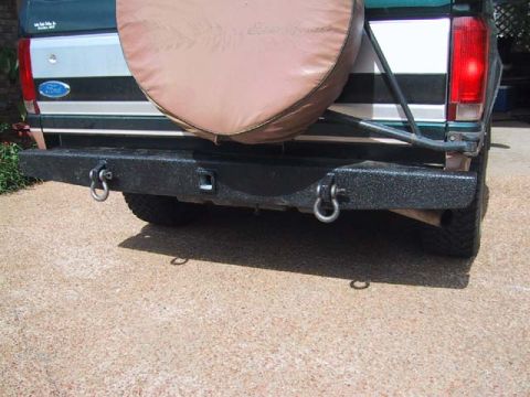1995 Ford Bronco - Aftermarket rear bumper assembly with integrated tow hooks and spare tire carrier.