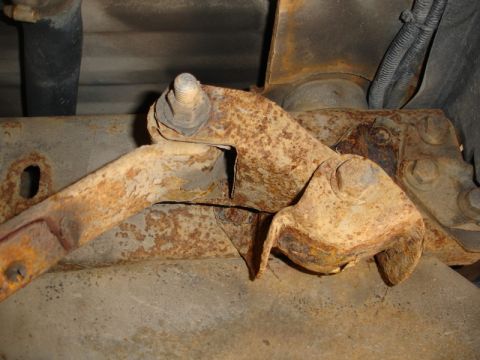 1996 Ford Bronco - Detail of heavily rusted suspension components, likely from the undercarriage of a vehicle.