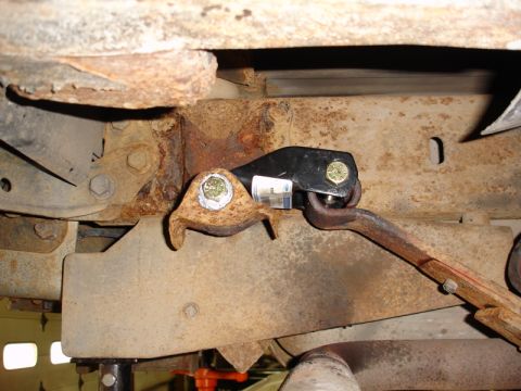 1996 Ford Bronco - Detail of a vehicle's undercarriage, showing significant rust on the frame and suspension components.